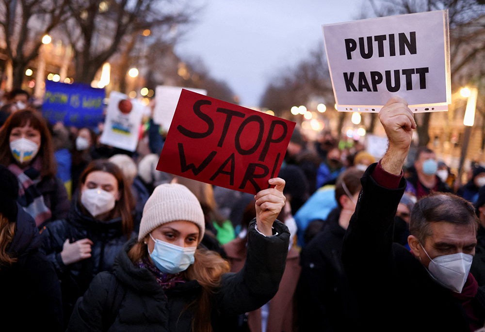 Demonstrators in front of the Russian Embassy Feb. 22, 2022, in Berlin hold placards during an anti-war protest. (CNS/Reuters/Christian Mang)