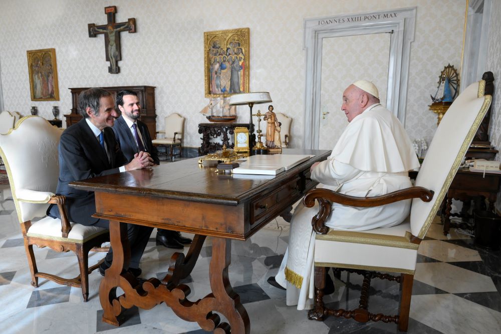 Pope Francis speaks with Rafael Grossi, director general of the International Atomic Energy Agency, during a meeting Jan. 12, 2023, in the library of the Apostolic Palace. Grossi said they discussed the threat of a disaster from bombings of a nuclear power plant in Ukraine. (CNS photo/Vatican Media)