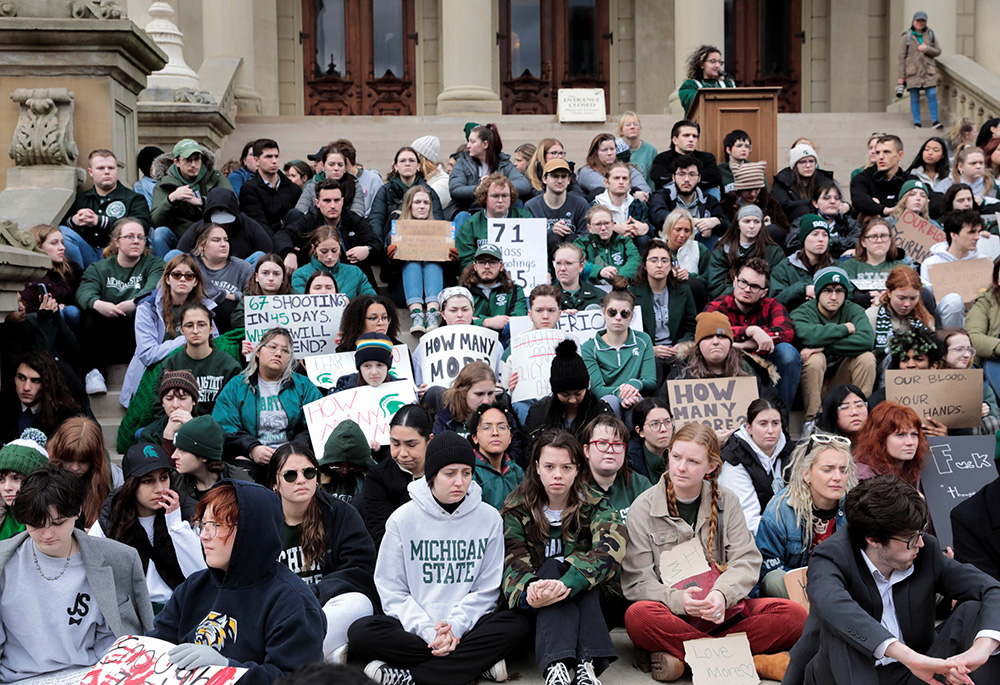 Michigan State University students protest for gun control in front of the State Capitol in Lansing Feb. 15 following a mass shooting at the campus. A gunman who opened fire at the university the previous day left three dead and five others critically injured. The shooter eventually killed himself, police announced early that morning. (OSV News/Reuters/Rebecca Cook)