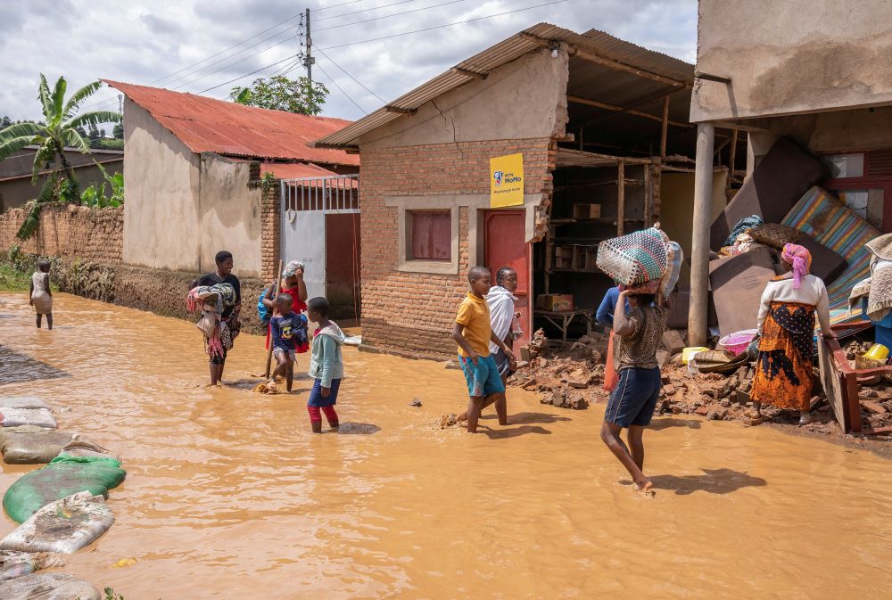 Residents wade through water after their homes were swamped, following rains that triggered flooding and landslides in Rubavu, Rwanda, May 3, 2023. As the death toll from the flooding and landslides in neighboring Congo surpassed 400, Catholic bishops in the country expressed their deep sorrow and called for support.