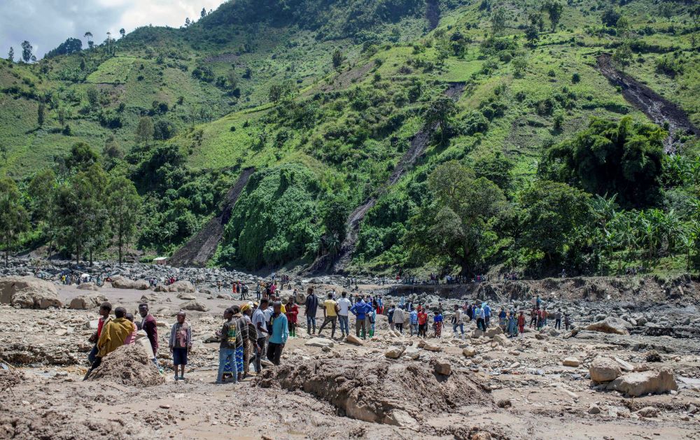 Congolese civilians gather in the village of Nyamukubi, May 6, 2023, after the death of their family members following flooding and landslides that destroyed buildings and forced aid workers to gather mud-clad corpses into piles. (OSV News photo/Reuters)
