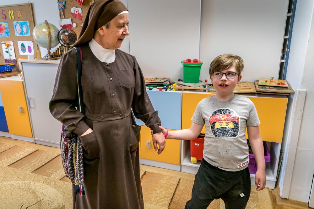 Sister Angelica of the Franciscan Sisters Servants of the Cross talks with a visually impaired refugee student from Ukraine at their monastery in Laski, Poland, in this May 20, 2022, photo. (CNS photo/Lisa Johnston)