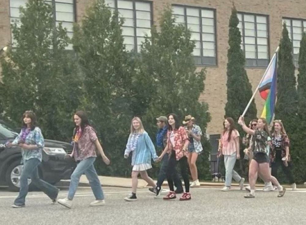 On the last day of class for seniors at St. Thomas Aquinas in Dover, New Hampshire, soon-to-be graduates carry a flag in support of the school's LGBTQ community and four teachers whose contracts were not renewed.