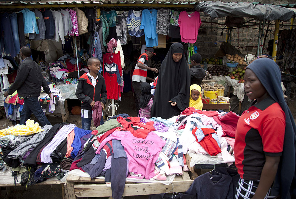 People look through piles of secondhand clothes at a roadside stall in Nairobi, Kenya, April 8, 2018. (AP/Sayyid Abdul Azim)