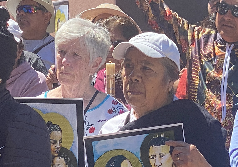 Mercy Sr. Mary Waskowiak, left in white, joins members of Our Lady of Guadalupe parish as they pray May 7 for compassionate asylum laws in front of the federal building that houses U.S. Immigration and Customs Enforcement in downtown San Diego. Almost 200 attended the event, which marks the start of a novena May 7-12, an effort by Jesuit organizations calling on the government to provide refuge to those seeking it. (NCR photo/Rhina Guidos)