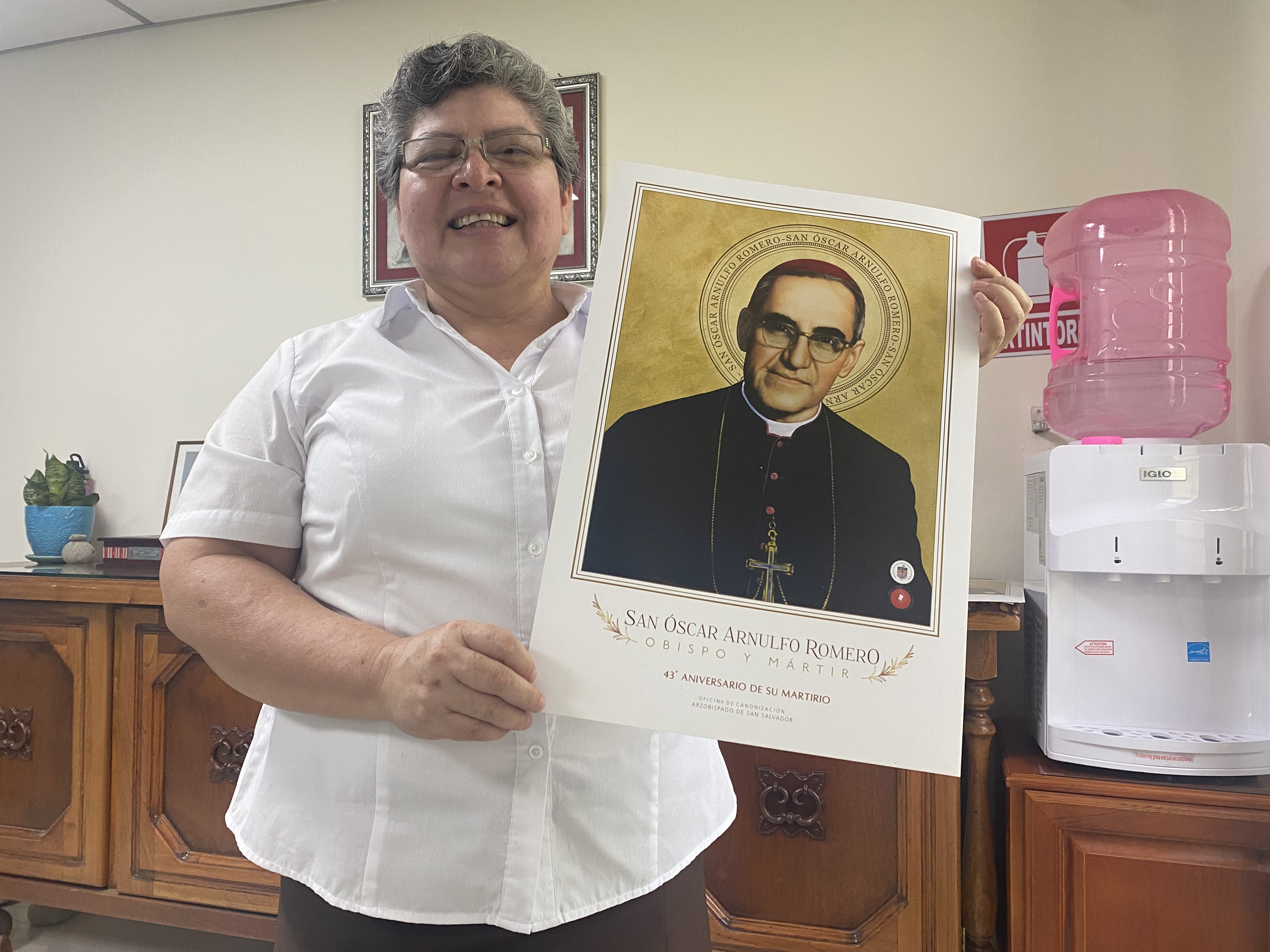 Sr. Tránsito de la Cruz Valdez Crespín holds a poster of St. Oscar Romero March 24, in her office close to the chapel where he was martyred. Valdez is the superior of the Missionary Carmelites of St. Teresa, who care for the house the Salvadoran saint lived on the grounds of the hospital for poor cancer patients that the religious community still operates. (GSR photo/Rhina Guidos)