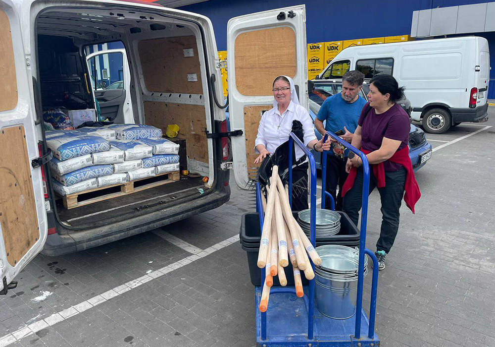 Sr. Lydia Timkova, Katarína Pajerská, who coordinates the Slovak mission of Caritas in Ukraine, and an unidentified man helping the women for the cross-country mission to supply eastern Ukrainians with humanitarian supplies. (Courtesy of Lydia Timkova)