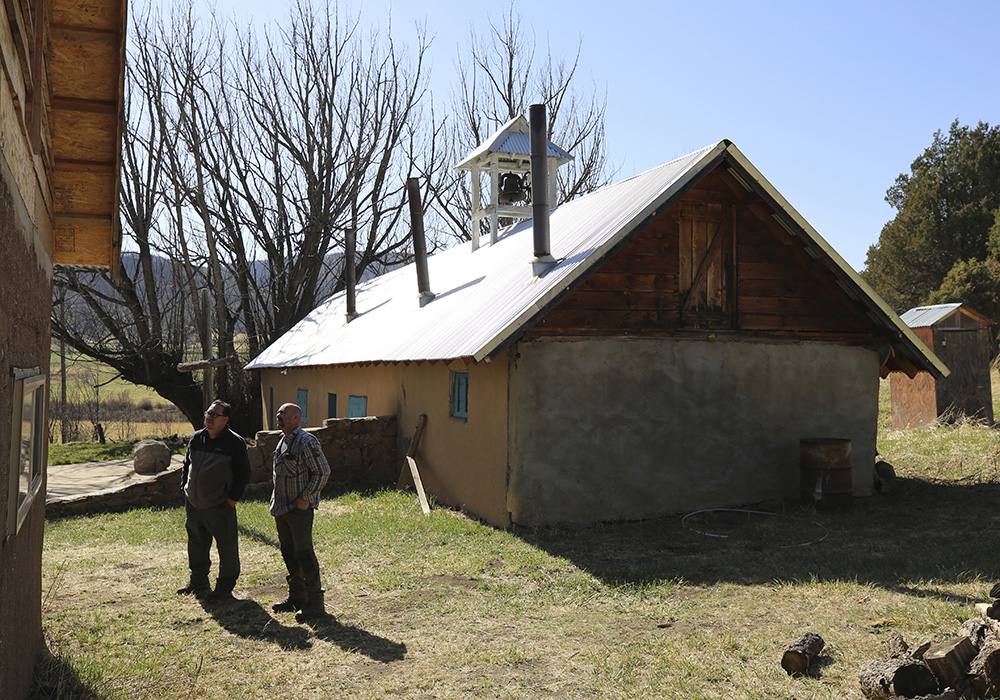 Fidel Trujillo, left, and Leo Paul Pacheco, look at the kitchen recently built with adobe next to the 1860s morada de San Isidro, which is the main chapel and meeting point of their Catholic brotherhood, outside Holman, New Mexico, on April 15. The morada is used for prayer, study and hosting pilgrims, all traditions for the brotherhood that for centuries have played a crucial role in preserving the faith in these remote mountain valleys. (AP Photo/Giovanna Dell'Orto)