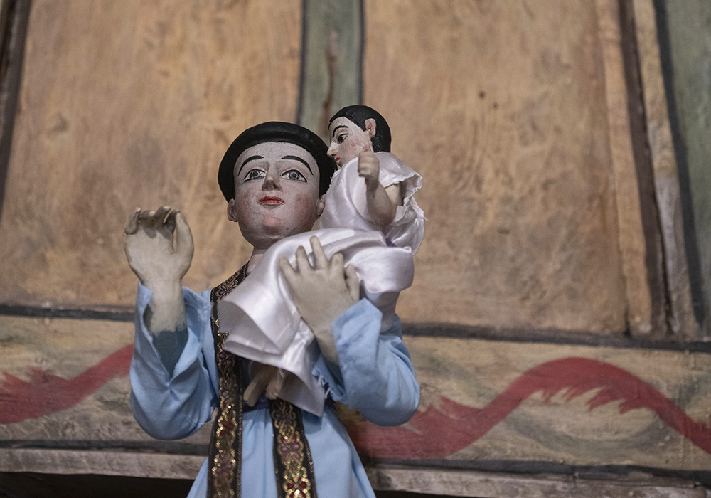 A bulto, or wooden statue, depicting St. Anthony stands inside St. Anthony's Catholic Church, April 14 in Cordova, New Mexico. (AP photo/Roberto E. Rosales)