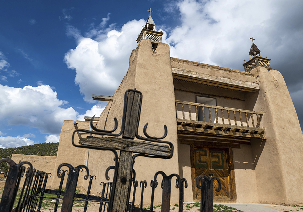 An exterior view of the San Jose de Gracia Catholic Church, built in 1760, April 14 in Las Trampas, New Mexico. Threatened by depopulation, dwindling congregations and fading traditions, some faithful are fighting to save their historic adobe churches and the uniquely New Mexican way of life they represent. (AP photo/Roberto E. Rosales)