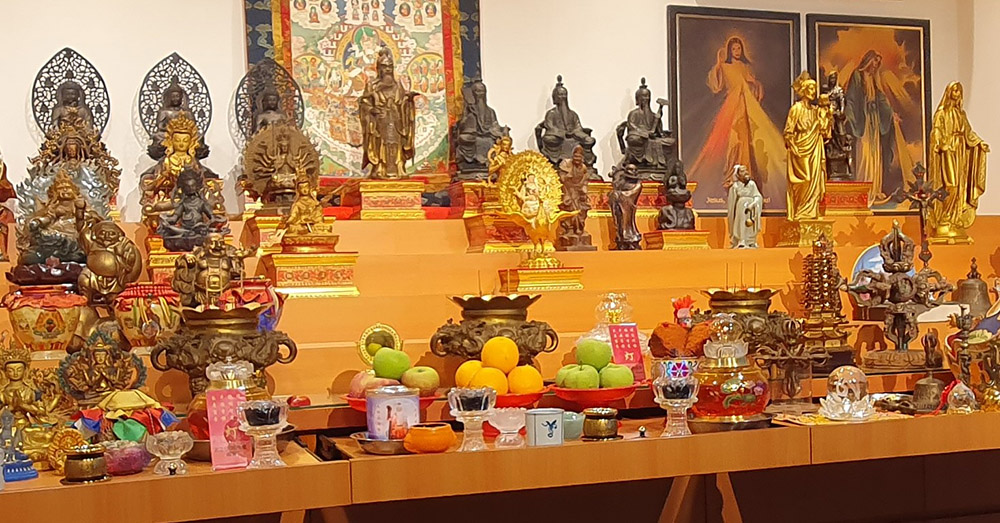 An altar at the headquarters of the Origin of the Self in Singapore represents the many deities venerated by the movement, including Jesus, Mary and St. Joseph, as seen upper right. (Michel Chambon)
