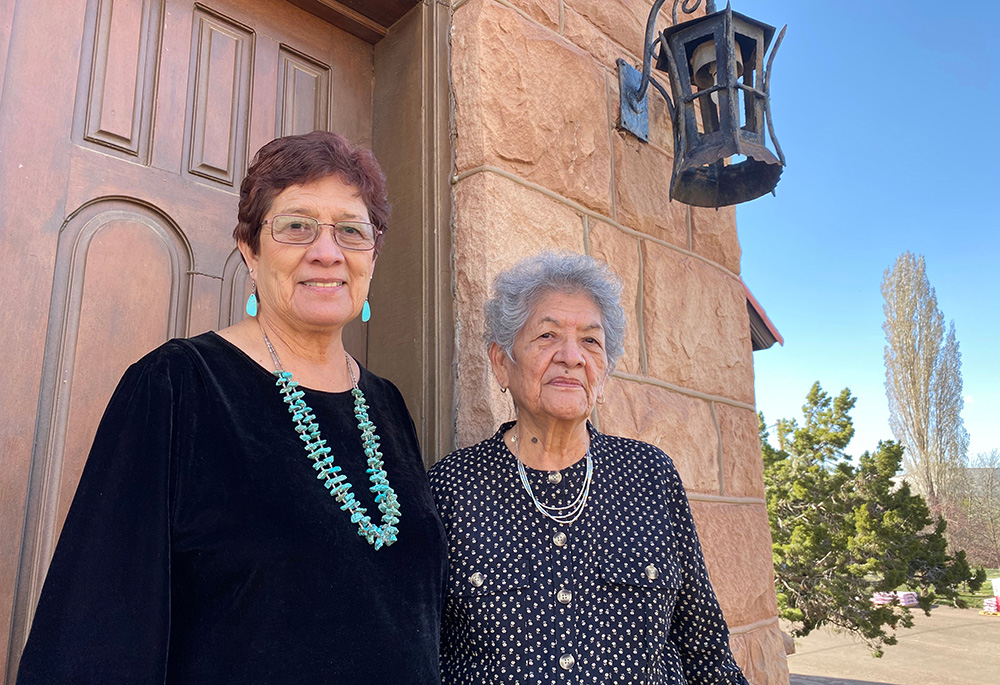 Teresa Sells-Gorman, left, and Patsy Billison stand in front of the Mary Mother of Mankind Church at the historic St. Michael's Mission, first established by Franciscan friars among the Navajo people in 1898. Sells-Gorman's father-in-law helped quarry the stones that were used to build the church. (Elizabeth Hardin-Burrola)