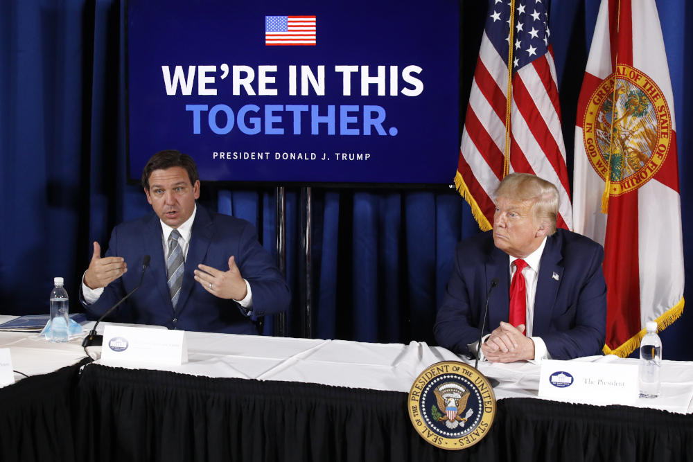 Florida Gov. Ron DeSantis, left, speaks alongside President Donald Trump during a roundtable discussion on the coronavirus outbreak and storm preparedness at Pelican Golf Club in Belleair, Florida, July 31, 2020. Before Trump and DeSantis were leading rivals for the 2024 Republican presidential nomination, they were allies. (AP file/Patrick Semansky)