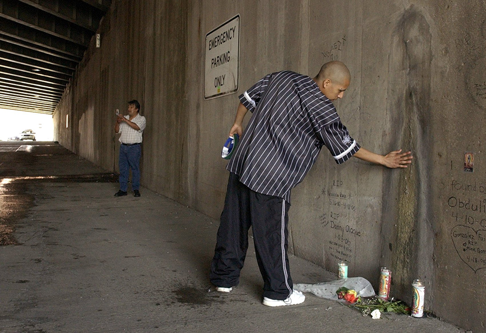 A man walks up and touches an image some people think looks like the Virgin Mary seen underneath the Kennedy Expressway in Chicago April 18, 2005. At the time, many Chicagoans came by to view the image, pray or take pictures of it. (CNS photo/Karen Callaway) 