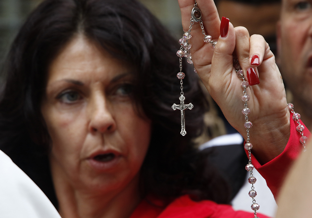 A woman holds a rosary as she joins other pro-life advocates in reciting the rosary during a monthly "Witness for Life" prayer vigil held across the street from a Planned Parenthood center Oct. 6, 2018, in New York City. (CNS/Gregory A. Shemitz)