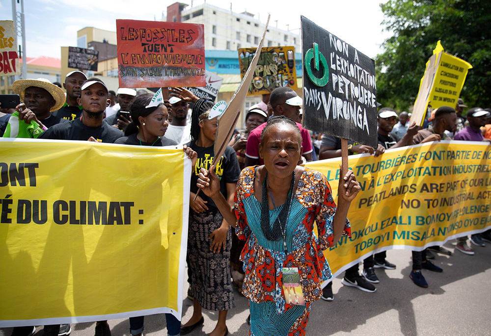 A woman leads environmental activists as they participate in a climate protest Nov. 29, 2019, in the streets of Kinshasa, Congo. Catholics in Africa celebrate the Congo Basin as the second lung of the earth and call for its protection to fight climate change. (CNS/Reuters/Hereward Holland)