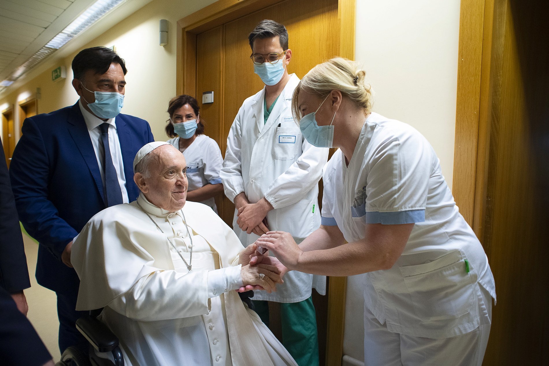 Pope Francis gives a rosary to a member of the medical staff at Gemelli hospital in Rome July 11, 2021, as he recovers following scheduled colon surgery. The pope was in the hospital for 10 days. (CNS photo/Vatican Media via Reuters)