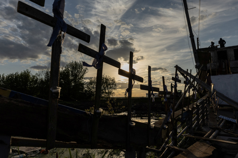 Crosses are attached to the destroyed bridge in Irpin, Ukraine, May 16, 2022, during Russia's invasion of Ukraine. (CNS/Reuters/Jorge Silva)
