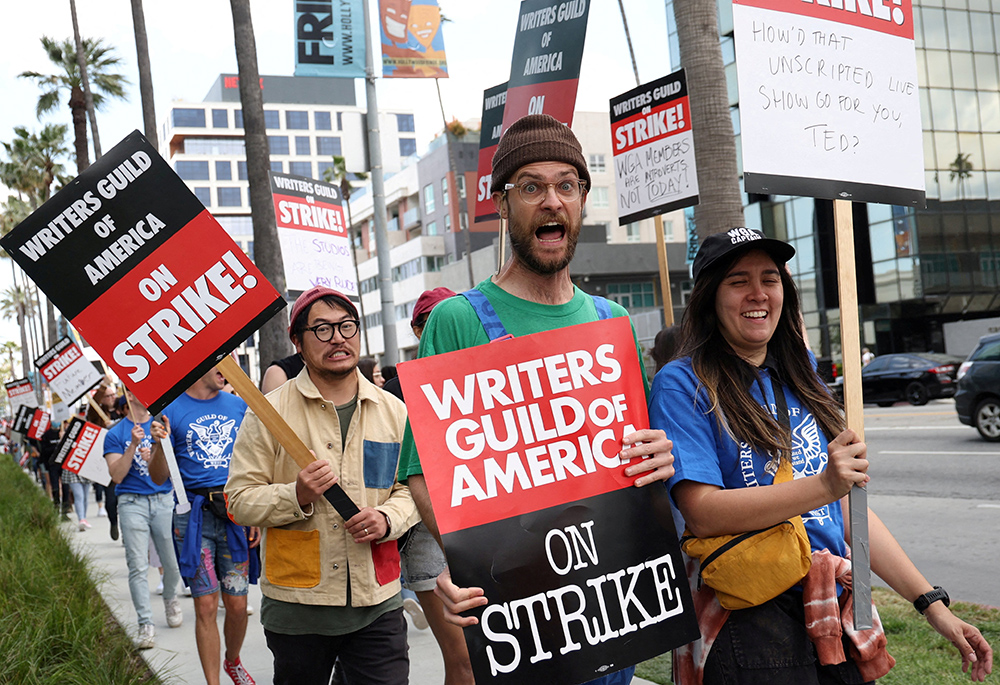 Writers Guild of America members and supporters picket outside Sunset Bronson Studios and Netflix Studios May 3 in Los Angeles, a day after union negotiators called a strike for film and television writers. (OSV News/Reuters/Mario Anzuoni)