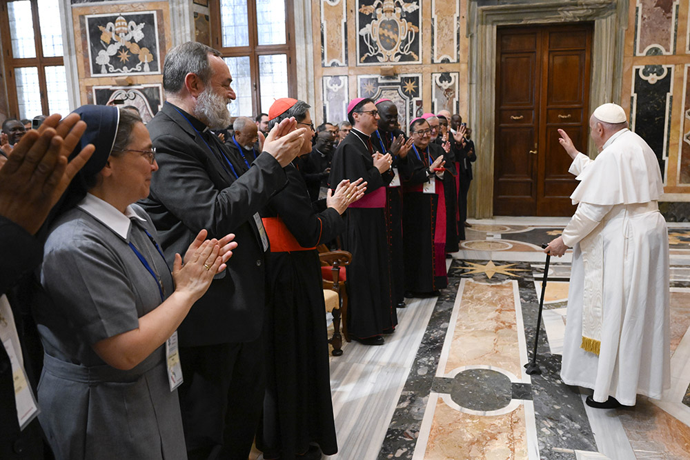 Pope Francis greets the Vatican staff and national directors of the Pontifical Mission Societies in the Apostolic Palace at the Vatican June 3 during the societies' annual meeting. (CNS/Vatican Media)