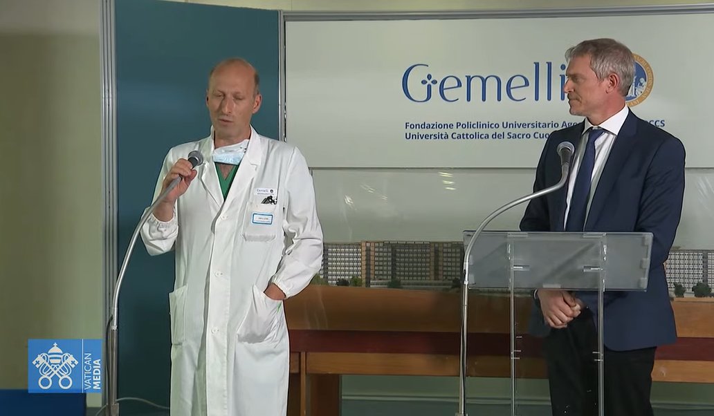 Matteo Bruni, director of the Vatican Press Office, looks at Dr. Sergio Alfieri, a chief surgeon at Rome's Gemelli's hospital, who operated on Pope Francis June 7, 2023, and speaks to reporters at the hospital as seen in this screengrab of the news conference broadcast live by Vatican Media. Alfieri said the pope was recoverying well from a three-hour surgery for a hernia. (CNS screengrab/Courtesy Vatican Media)