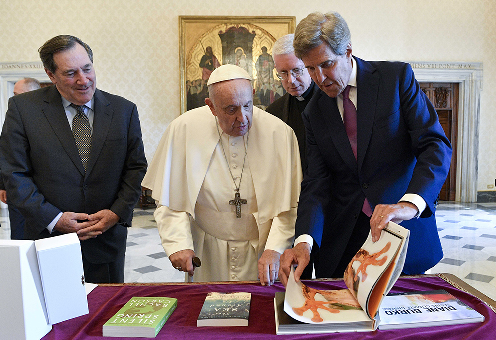Pope Francis looks at a gift offered by John Kerry, President Biden's special envoy for climate issues, right, during a meeting that also included Joe Donnelly, U.S. ambassador to the Holy See, left, June 19 at the Vatican. (CNS photo/Vatican Media)