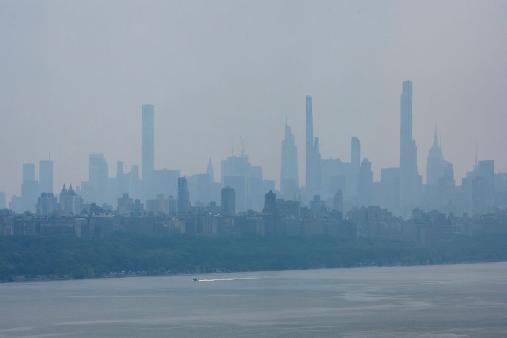Haze and smoke caused by wildfires in Canada linger over the skyline of midtown Manhattan in New York City as seen from Fort Lee, N.J. June 8, 2023. Wildfires have always occurred, but experts say the warming climate is increasing their severity. (OSV News photo/Mike Segar, Reuters)