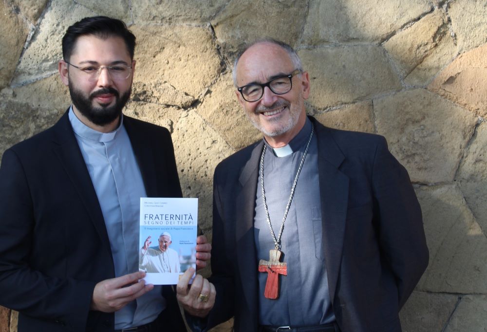 Fr. Christian Barone (left) and Cardinal Michael Czerny are pictured with their book in Italian, "Fraternity: Sign of the Times," in Rome on Sept, 30, 2021. 
