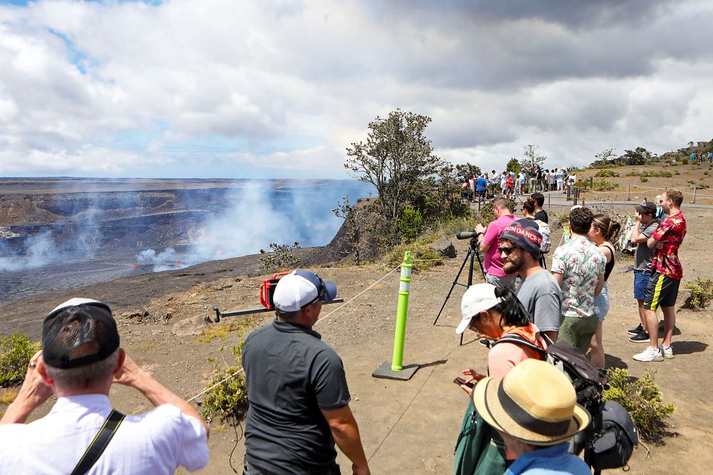 Visitors line the side of an overlook to view the Kilauea eruption in Hawaii on Wednesday, June 7, 2023. Hawaii tourism officials are urging tourists to be respectful when flocking to a national park on the Big Island to get a glimpse of the latest eruption of Kilauea.