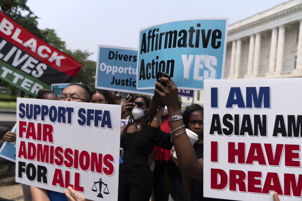 Demonstrators protest outside of the Supreme Court in Washington June 29, after the Supreme Court struck down affirmative action in college admissions, saying race cannot be a factor. (AP/Jose Luis Magana)