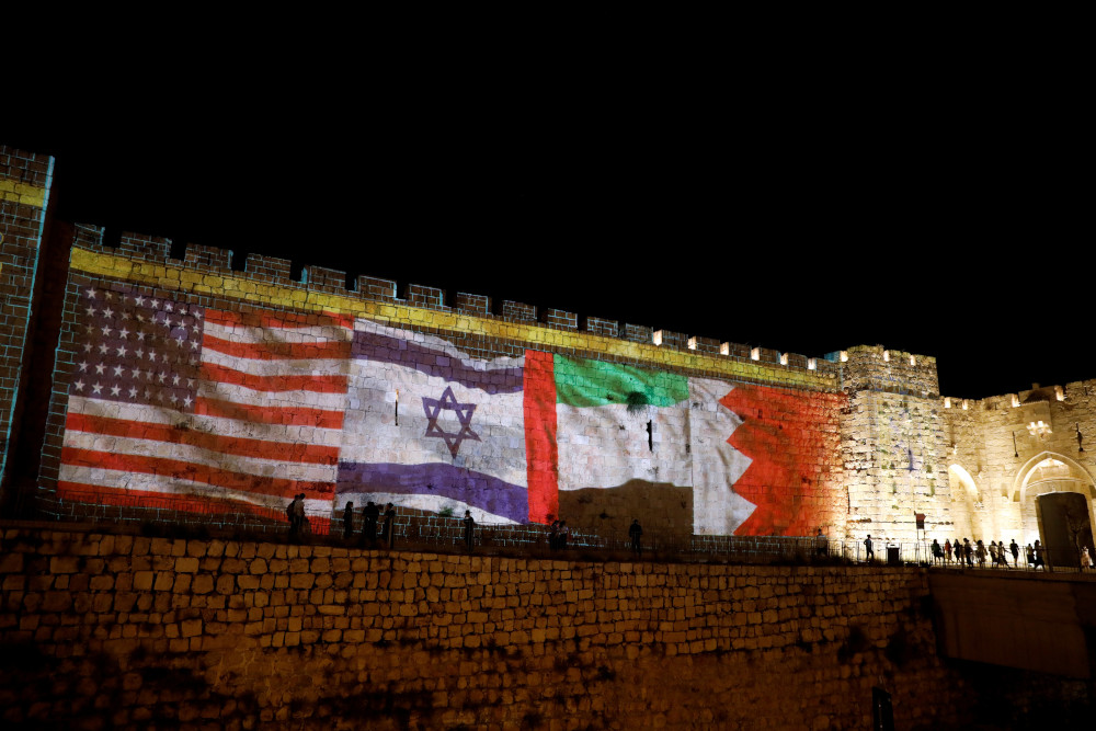 The flags of the United States, Israel, United Arab Emirates and Bahrain are projected on a section of the walls surrounding Jerusalem's Old City Sept. 15, 2020, as United Arab Emirates and Bahrain sign agreements toward normalizing relations with Israel at a White House ceremony in Washington. (CNS/Reuters/Ronen Zvulun)
