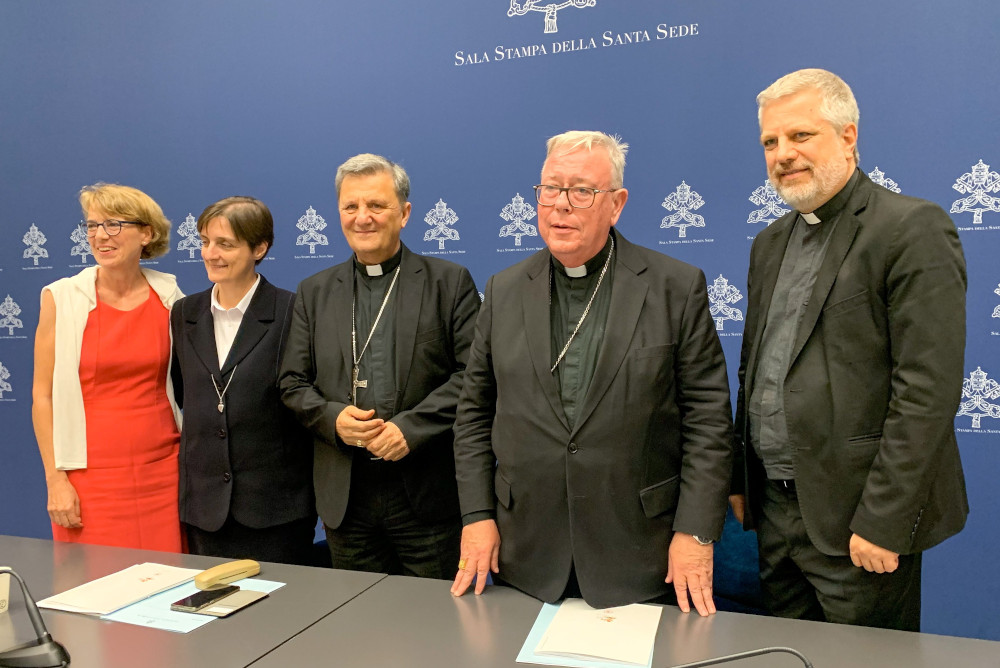 The people who presented the working document for the Synod of Bishops pose for a photo in the Vatican press office June 20. From the left are Helena Jeppesen-Spuhler, a synod participant from Switzerland; Sr. Nadia Coppa, president of the women's International Union of Superiors General; Cardinal Mario Grech, secretary-general of the synod; Cardinal Jean-Claude Hollerich, relator general of the synod; and Jesuit Fr. Giacomo Costa, a consultant to the synod. (CNS/Cindy Wooden)