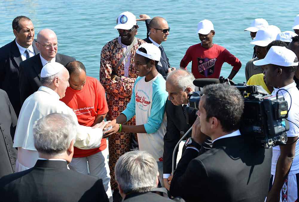 Pope Francis greets immigrants as he arrives at the port in Lampedusa, Italy, July 8, 2013. (CNS/Tullio Puglia, pool)
