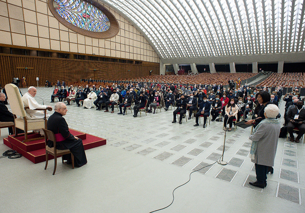 Pope Francis listens as Margaret Karram, the then-new president of the Focolare movement, speaks during an audience with participants in the general assembly of the Focolare movement, in the Paul VI hall Feb. 6, 2021, at the Vatican. The pope encouraged the movement to continue to grow in dialogue with the world today. (CNS/Vatican Media)