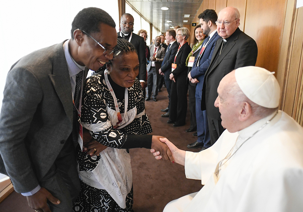 Pope Francis greets participants after speaking at a Vatican conference, "Pastors and lay faithful called to walk together," Feb. 18, in the Vatican synod hall. The meeting was sponsored by the Dicastery for Laity, the Family and Life. This October's meeting on the future of the church will take place in the larger Pope Paul VI audience hall. (CNS/Vatican Media)