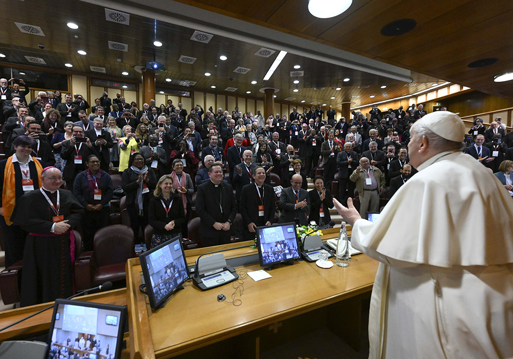 Pope Francis greets participants at a Vatican conference, "Pastors and lay faithful called to walk together," Feb. 18, in the Vatican synod hall. The meeting was sponsored by the Dicastery for Laity, the Family and Life. (CNS/Vatican Media)
