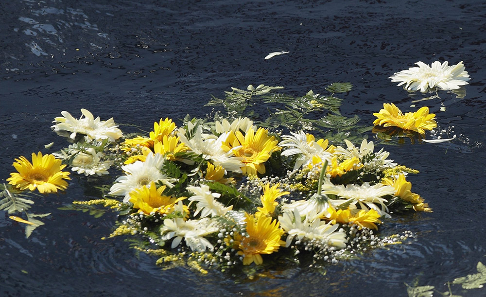 A wreath of flowers thrown by Pope Francis floats in the Mediterranean Sea in the waters off the Italian island of Lampedusa on July 8, 2013. The pope threw the wreath to honor the memory of immigrants who have died trying to cross from Africa to reach a new life in Europe. (CNS/Paul Haring)