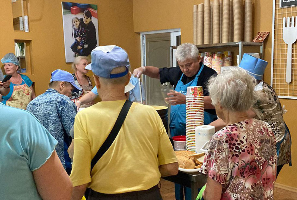 Cardinal Konrad Krajewski, prefect of the Vatican Dicastery for the Service of Charity, in Kherson on June 28, helps distribute humanitarian help to a community flooded after the destruction of the Kakhovka dam on June 6. (OSV News/Courtesy of Bishop Jan Sobilo) 