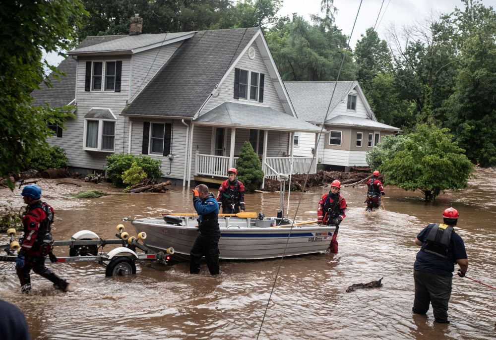Emergency personnel maneuver a boat used to rescue residents of flooded homes in Stony Point, N.Y., July 9, 2023. Severe storms that left at least one dead in Orange County, dumped heavy rainfall at intense rates over parts of the Northeast, forcing road closures, water rescues and urgent warnings about life-threatening flash floods.