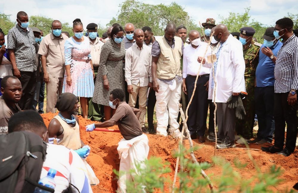 Kenyan authorities retrieve bodies from shallow graves April 27  on an 800-acre ranch in Kilifi County. 