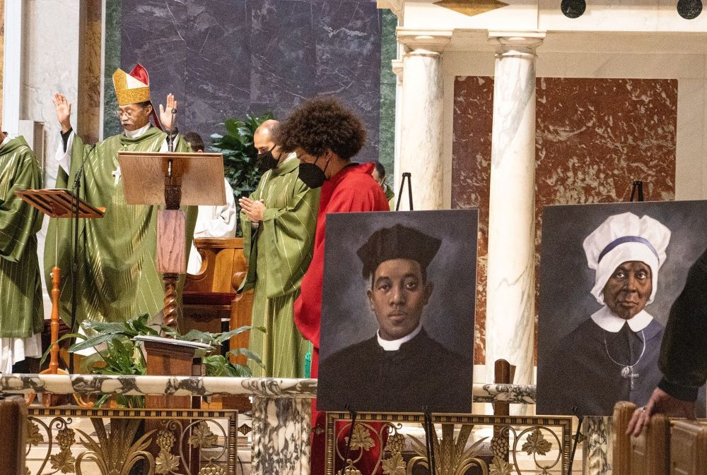 Auxiliary Bishop Roy E. Campbell Jr. of Washington, president of the National Black Catholic Congress, celebrates Mass Feb. 6, 2022, at St. Matthew's Cathedral to mark Black History Month. The 13th National Black Catholic Congress is July 20-23. The portraits on display are of Fr. Augustus Tolton and Mother Mary Elizabeth Lange, candidates for sainthood. (CNS photo/Javier Diaz, Catholic Standard)