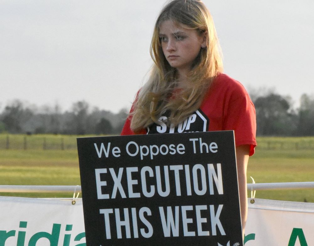 A student from Lourdes Academy Catholic School in Daytona Beach, Fla., stands for life in front of the Florida State Prison Feb. 23/