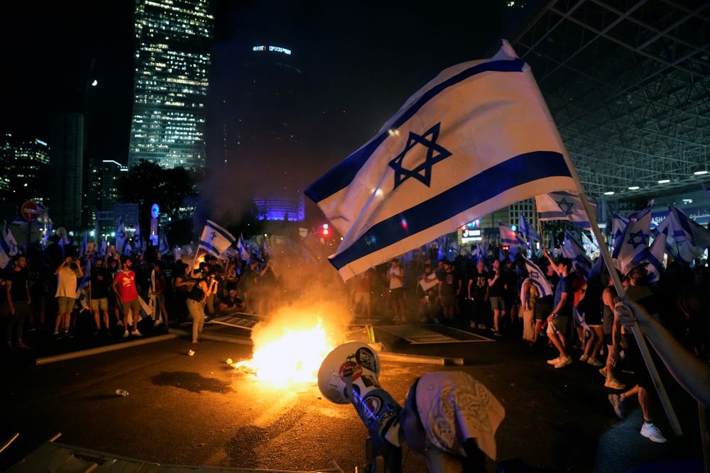 Israeli flag is seen among protesters in Tel Aviv.