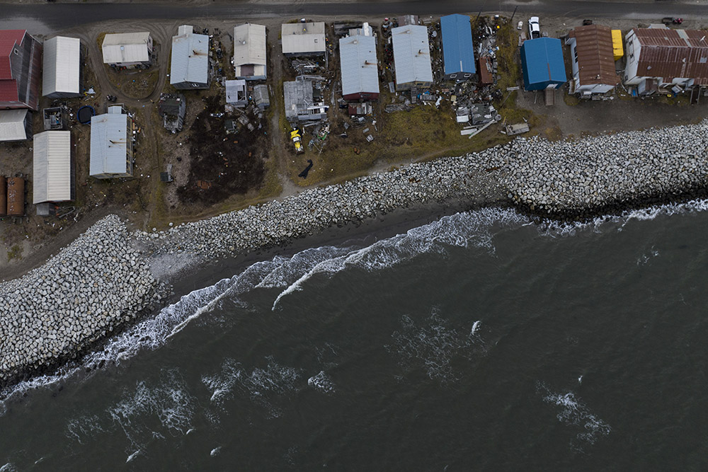 Small waves crash into reinforced seawalls on Oct. 4, 2022, in Shishmaref, Alaska, where the island Inupiat community faces rising sea levels, flooding, increased erosion and loss of protective sea ice and land. (AP/Jae C. Hong)