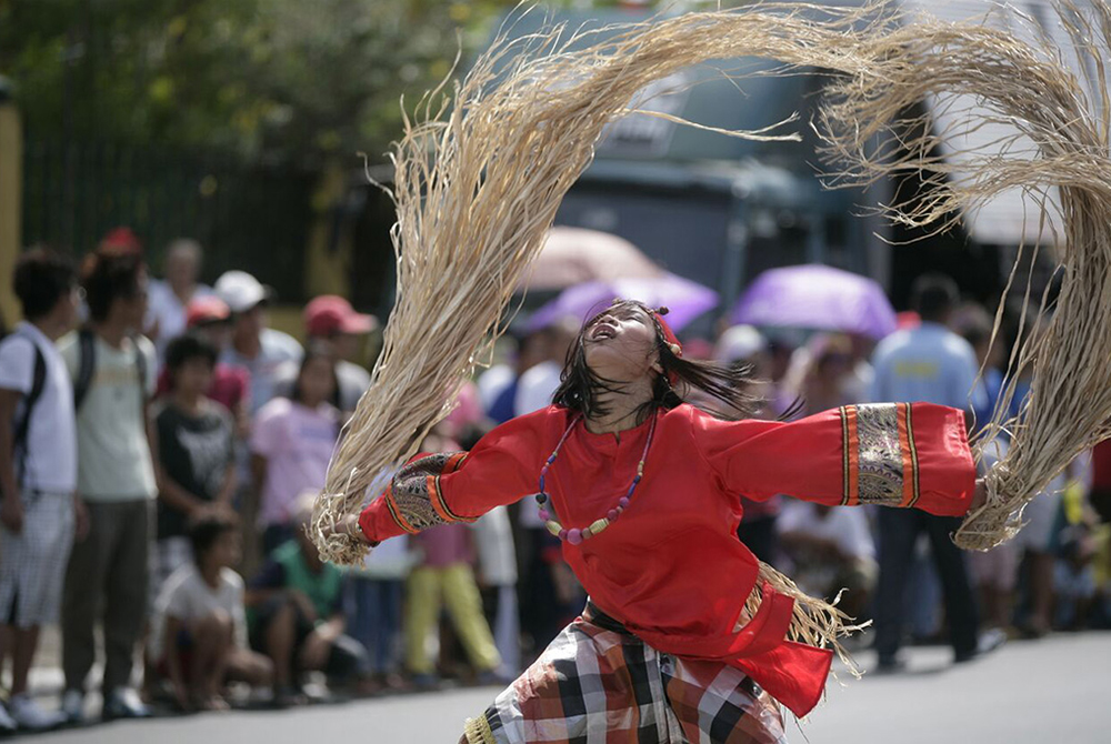 A performer representing a babaylan shaman is pictured at a traditional festival in Bago, in Negros Occidental, Philippines. As Donny Mioskowski Cámara writes about precolonial Philippines, "Masculine and feminine energies coexisted in the babaylan —  women and men — and these leaders were honored for their connection to the divine." (Wikimedia Commons/Hptina24, CC BY-SA 4.0)