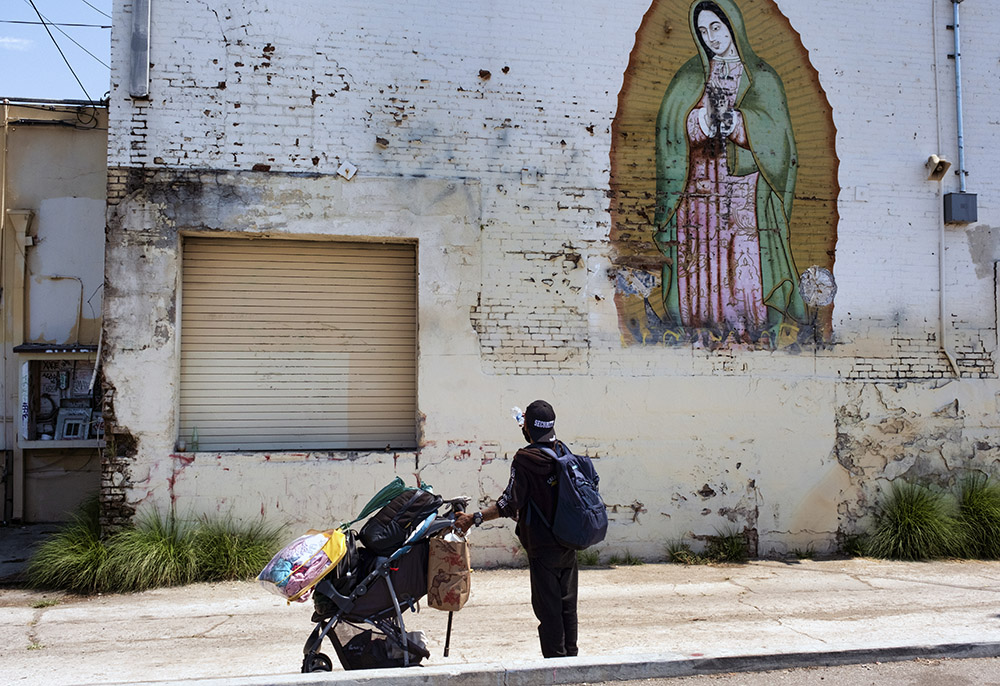 Henry Zeller, a homeless man who lives out of an RV on the street, stops to drink water to stay hydrated during the extreme heat in Los Angeles July 16. (AP/Richard Vogel)