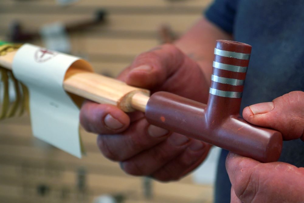Travis Erickson holds a handmade pipe that he carved and crafted from pipestone, which is sold in his shops, on Wednesday, May 3, 2023, in Pipestone, Minn.