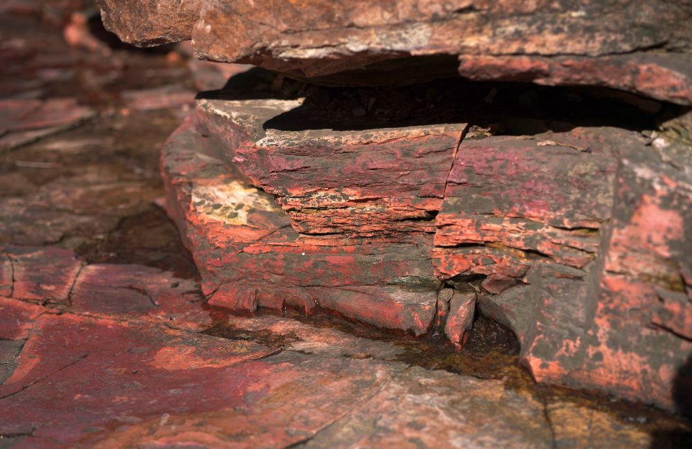 A layer of bright catlinite, the unique variety of soft pipestone used by Native Americans to carve pipes, is seen at the Pipestone National Monument on Wednesday, May 3, 2023, in Pipestone, Minn. For Native Americans, the quarries now part of Pipestone National Monument have been a sacred gathering place and a preferred source of pipestone for thousands of years. 