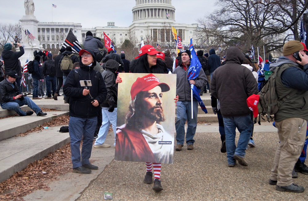 The image of a white Jesus is carried during the Jan. 6, 2021, insurrection at the Capitol. (Creative Commons/Flickr/Tyler Merbler)