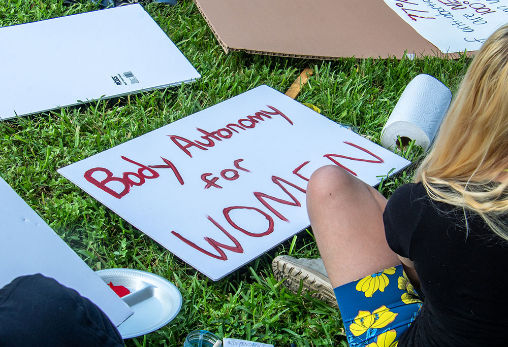 Young activists prepare placards for a demonstration in Lakeland, Florida, on June 30, 2022, protesting the U.S. Supreme Court's June 24 ruling in Dobbs v. Jackson Women's Health Organization, which overturned Roe v. Wade's protection of abortion rights. (Dreamstime/Marcello Sgarlato)